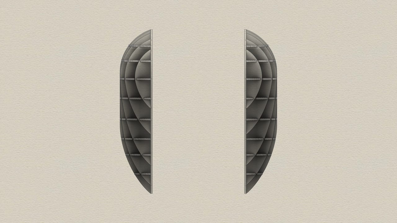 Two grey half-shapes with ribs visible inside, standing apart on a pale paper texture, like the two halves of a rounded form that has been sliced in two